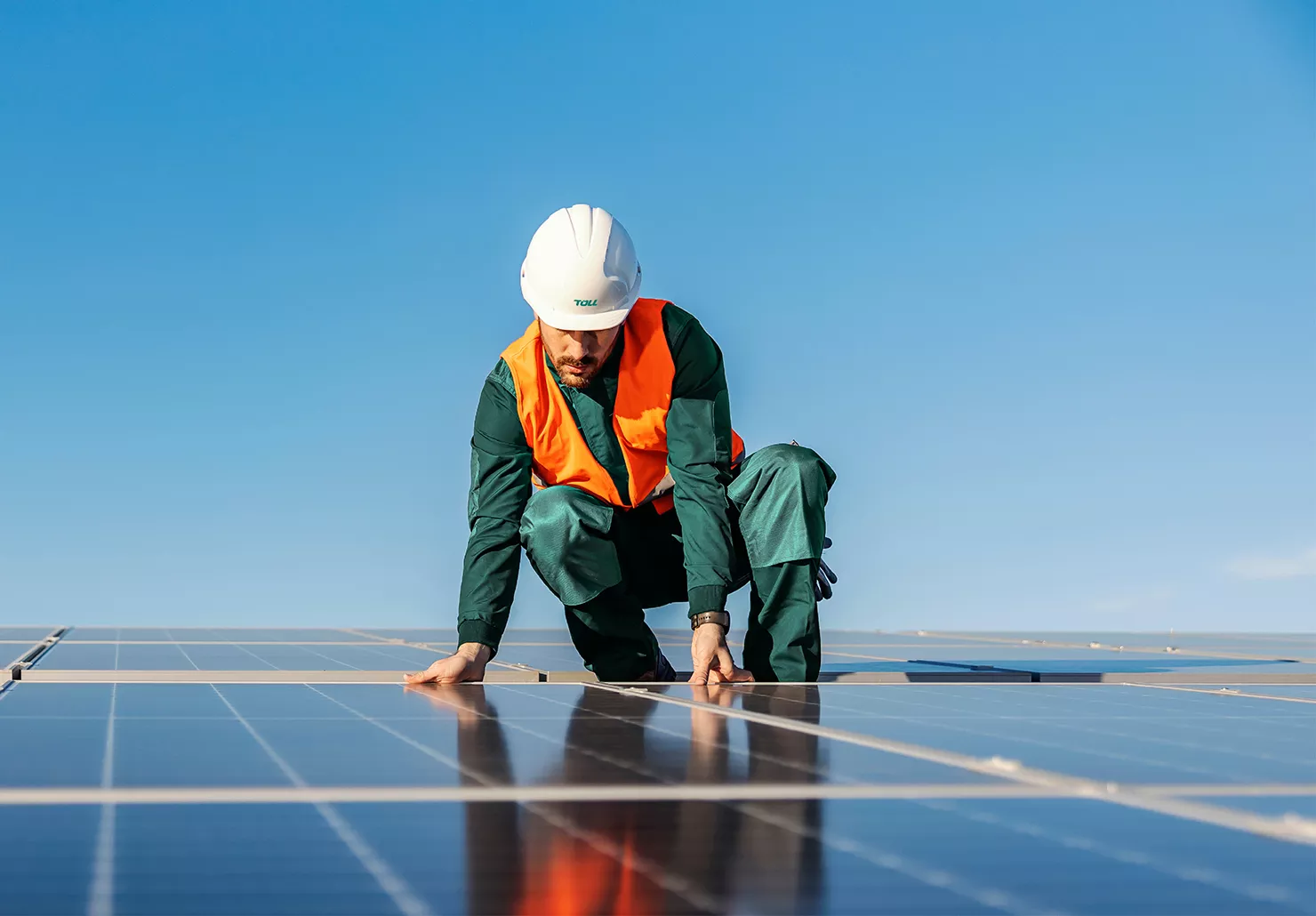 Toll team member on solar panels